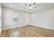 Living room featuring wood-look flooring, a ceiling fan, and ample natural light at 620 N Rural St, Indianapolis, IN 46201