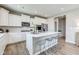 Modern kitchen with white cabinets, stainless steel appliances, and an island with bar seating at 67 Sterling Pl, New Whiteland, IN 46184