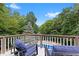 Relaxing backyard deck with seating, overlooking an in-ground pool and lush greenery at 7701 Center Lake Rd, Nineveh, IN 46164