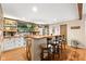 Basement bar with live edge wood countertop, white cabinets, and wood-paneled accent wall at 7701 Center Lake Rd, Nineveh, IN 46164