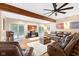 Finished basement with a fireplace, leather furniture, exposed beams and sliding glass doors at 7701 Center Lake Rd, Nineveh, IN 46164