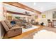 Finished basement with leather furniture, exposed beams and a bar at 7701 Center Lake Rd, Nineveh, IN 46164