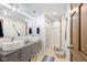 Modern bathroom with double vessel sinks, grey vanity, and unique light fixtures at 7701 Center Lake Rd, Nineveh, IN 46164