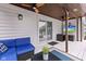 Covered deck with outdoor furniture, a TV, and sliding glass doors at 7701 Center Lake Rd, Nineveh, IN 46164