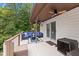 Covered deck with outdoor furniture, ideal for enjoying the wooded views at 7701 Center Lake Rd, Nineveh, IN 46164