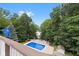 Deck view of the pool area, surrounded by trees at 7701 Center Lake Rd, Nineveh, IN 46164