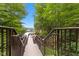 Wooden walkway with railings leading down to a dock and lake at 7701 Center Lake Rd, Nineveh, IN 46164