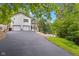 Paved driveway leading to a two-car garage and wooded backyard at 7701 Center Lake Rd, Nineveh, IN 46164