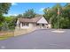 White two-story home with a split-rail fence and paved driveway at 7701 Center Lake Rd, Nineveh, IN 46164
