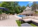 Inviting pool area with a deck, patio furniture, and lush trees at 7701 Center Lake Rd, Nineveh, IN 46164