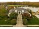 Luxury home with lake views and spacious grounds in autumn at 8804 Waterside Dr, Indianapolis, IN 46278