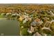 Aerial view of a lakefront community showcasing homes with fall foliage at 8804 Waterside Dr, Indianapolis, IN 46278