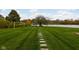 Landscaped lawn with a stone pathway leading to a tranquil lake at 8804 Waterside Dr, Indianapolis, IN 46278