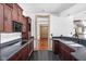 Dark wood cabinetry, granite countertops and black appliances at 8804 Waterside Dr, Indianapolis, IN 46278
