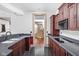 Dark wood cabinetry, granite countertops and black appliances at 8804 Waterside Dr, Indianapolis, IN 46278