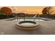 Spacious hot tub in the backyard patio with pool and sunset view at 8804 Waterside Dr, Indianapolis, IN 46278