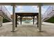 Elegant pool area framed by columns, featuring a fire pit and gazebo at 8804 Waterside Dr, Indianapolis, IN 46278