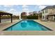 Inviting outdoor pool with a hot tub and a waterslide, surrounded by a spacious patio at 8804 Waterside Dr, Indianapolis, IN 46278