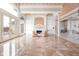 Bright sitting room with marble floors, fireplace, and French doors leading to a deck at 8804 Waterside Dr, Indianapolis, IN 46278