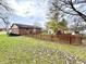 Fenced backyard with playset, shed, deck, and grassy area at 100 W Hillsboro Dr, Pendleton, IN 46064