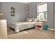 Blue-themed bedroom with a comfortable bed, nightstand, and a window with natural light at 10389 Hillsborough Dr, Fishers, IN 46037