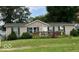 Ranch-style home with green lawn and deck at 105 S Church St, Martinsville, IN 46151