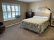 Cozy bedroom with large window, plush carpet, and neutral decor at 11336 Cherry Blossom W Dr, Fishers, IN 46038