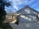 Front exterior of a home with attached two-car garage and brick facade at 11336 Cherry Blossom W Dr, Fishers, IN 46038