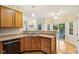 Kitchen with oak cabinets, double sink, and view of the backyard at 1140 Scarlet Quarry Cir, Avon, IN 46123