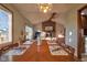 Dining area with table set for four, opening up to the living room with brick fireplace at 11721 Sterrett Blvd, Indianapolis, IN 46236