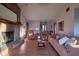 Living room centered around a cozy fireplace, wood floors, and comfortable furnishings at 11721 Sterrett Blvd, Indianapolis, IN 46236