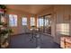 Sunroom with outdoor access, sliding glass doors, a small table and chairs, and plant shelving at 11721 Sterrett Blvd, Indianapolis, IN 46236