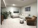 Inviting basement living area with sectional sofa, armchair, and soft lighting at 12004 Tavernier Dr, Fishers, IN 46037