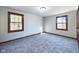 Cozy bedroom with plush carpeting and two large windows providing natural light at 2604 Albert St, Anderson, IN 46012