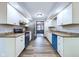 Stylish kitchen with white cabinets, stainless steel appliances, and a wood-look floor at 2604 Albert St, Anderson, IN 46012