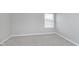 Empty bedroom with gray carpet and a window at 302 Fairfax Ln, Greenwood, IN 46142