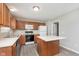 Bright kitchen featuring ample wooden cabinetry, a center island, and modern appliances at 302 Fairfax Ln, Greenwood, IN 46142