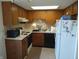 Kitchen with wooden cabinets, white countertops, and black appliances at 316 Elmead Ct # 1005, Greenwood, IN 46142