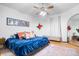 Spacious main bedroom with a king-size bed, stained glass window, and ceiling fan at 321 N State St, Greenfield, IN 46140