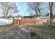 Fenced backyard with a wooden gate and a paved area at 3458 N Kenwood Ave, Indianapolis, IN 46208