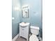 Bathroom with light blue walls, a white vanity, and a standard toilet at 3458 N Kenwood Ave, Indianapolis, IN 46208