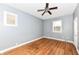 Empty bedroom with hardwood floors, ceiling fan, and gray walls at 3458 N Kenwood Ave, Indianapolis, IN 46208