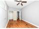Bedroom with hardwood floors, ceiling fan, open closet and access to another room at 3458 N Kenwood Ave, Indianapolis, IN 46208