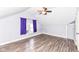 Purple bedroom with wood-look floors, ceiling fan, and window with purple curtains at 3458 N Kenwood Ave, Indianapolis, IN 46208