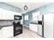 Modern kitchen featuring white cabinets, black appliances, and ample counter space at 3458 N Kenwood Ave, Indianapolis, IN 46208