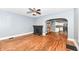 Living room with hardwood floors, a black brick fireplace, and an open archway to the kitchen at 3458 N Kenwood Ave, Indianapolis, IN 46208