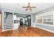 Spacious living room with hardwood floors, a staircase, and an open view of the kitchen at 3458 N Kenwood Ave, Indianapolis, IN 46208