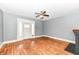 Living room featuring hardwood floors, a black brick fireplace, and a white front door at 3458 N Kenwood Ave, Indianapolis, IN 46208