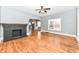 Living area with hardwood floors, a black fireplace, and large windows providing ample natural light at 3458 N Kenwood Ave, Indianapolis, IN 46208