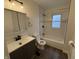 Updated bathroom with tub, vanity, and dark gray cabinetry at 3919 E 34Th St, Indianapolis, IN 46218
